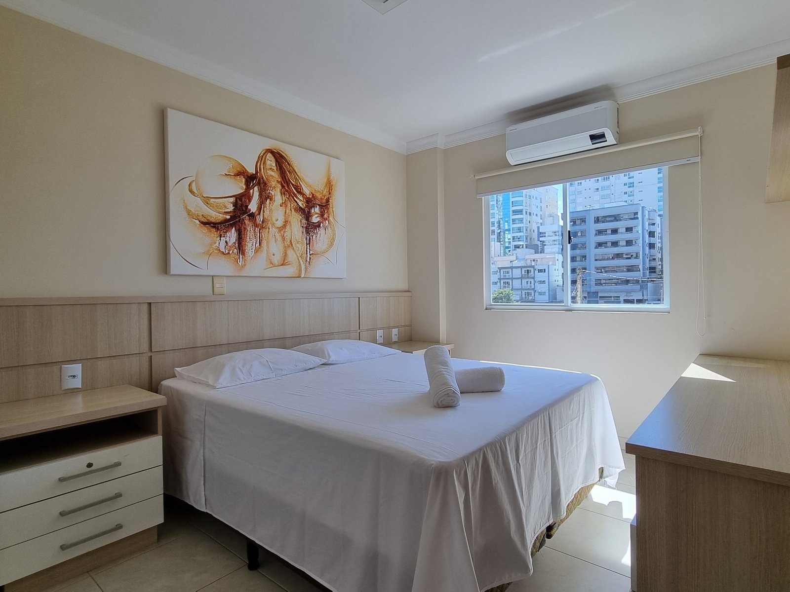 Suíte com painel em madeira ripada