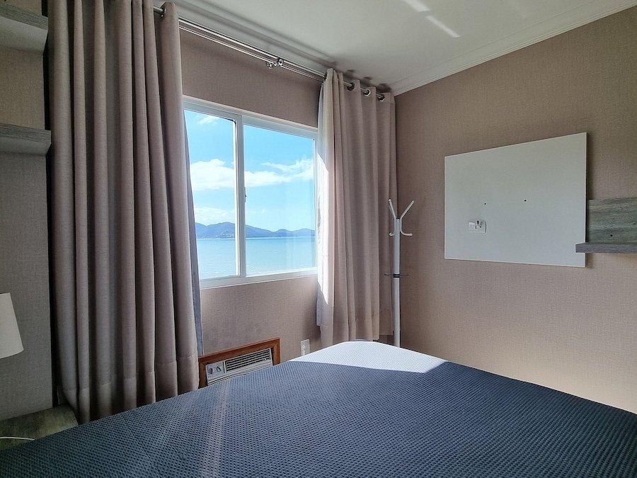Quarto com cama de casal e vista mar