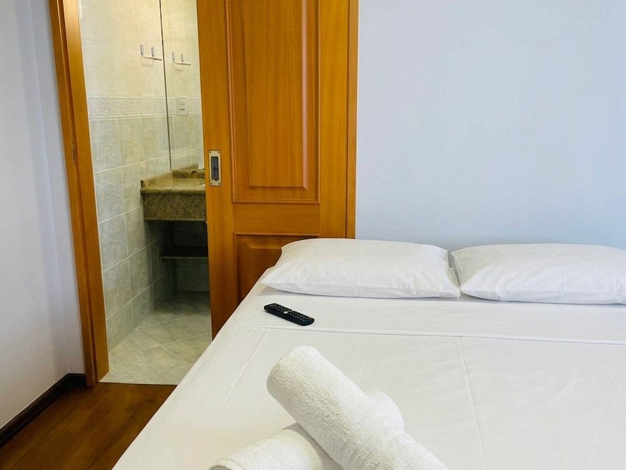 Suíte com cama de casal e banheiro próprio ao lado